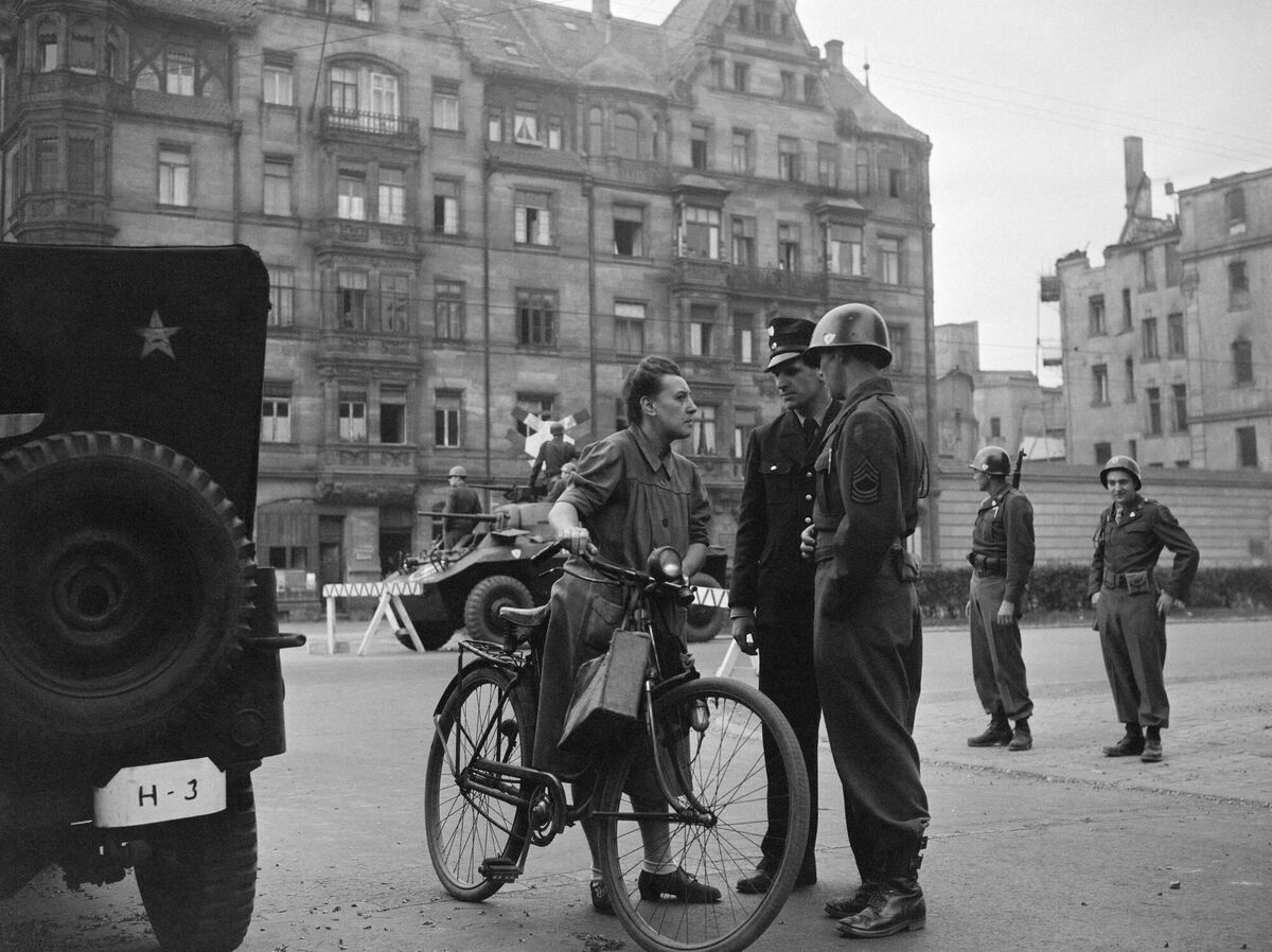 A policeman and a soldier talk with a woman while surveying the street near the law court of Nuremberg on September 1946 during the trial against the surviving leaders of the Nazi machine. File picture: AFP/Getty A policeman and a soldier talk with a woman while surveying the street near the law court of Nuremberg on September 1946 during the trial against the surviving leaders of the Nazi machine. File picture: AFP/Getty