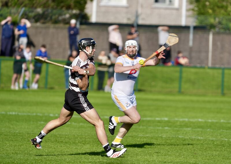 Midleton’s Paul Haughney looks to score a point as Bandon’s Sean Carey closes in. Pic: Noel Sweeney