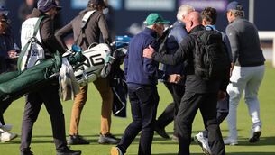<p>Dermot Desmond being escorted off by security. Pic: Steve Welsh/PA Wire.</p>