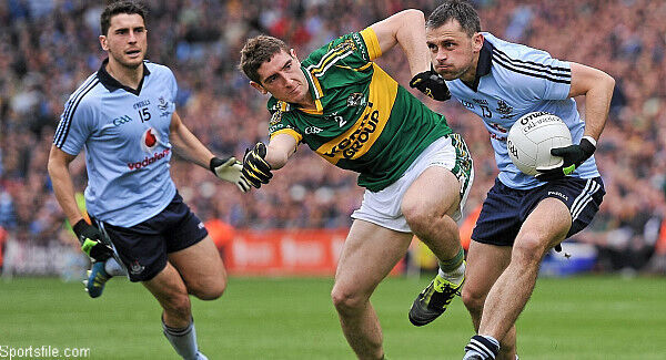 Alan Brogan with support from Bernard as he is tackled by Kerry's Killian Young in the 2011 All-Ireland Football Final. Pic: Sportsfile