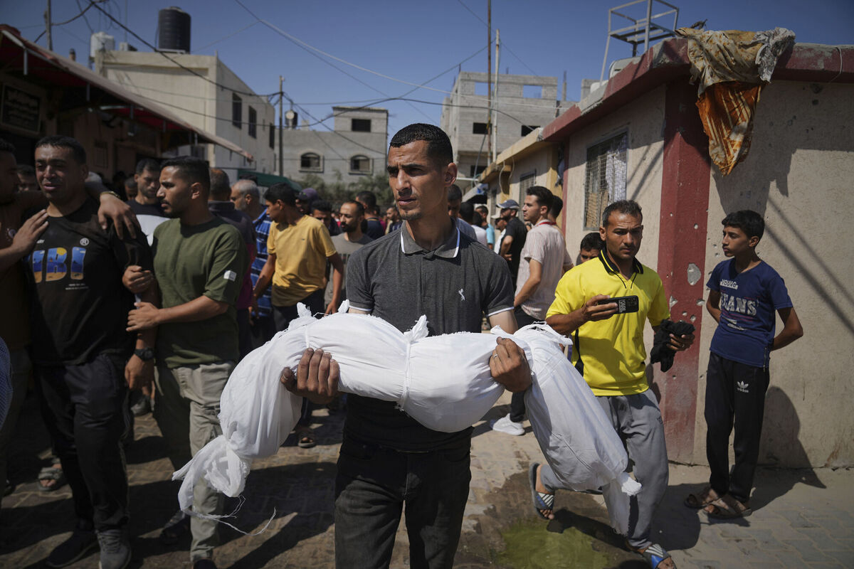 A relative carries the body of Palestinian girl Mira Bashir, 10, who was killed with her sister, Sabah, 8, in an Israeli army airstrike of the Gaza Strip, during their funeral in Deir al-Balah, on July 2, 2025. Picture: Abdel Kareem Hana/AP
A relative carries the body of Palestinian girl Mira Bashir, 10, who was killed with her sister, Sabah, 8, in an Israeli army airstrike of the Gaza Strip, during their funeral in Deir al-Balah, on July 2, 2025. Picture: Abdel Kareem Hana/AP