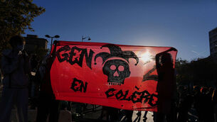 Students hold a banner reading ‘youth in anger’ as they gather before a demonstration against under-resourced schools, in Paris (Aurelien Morissard/AP)