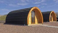 Wooden Glamping pod in a glamping village with yurts and gravel paths Ireland