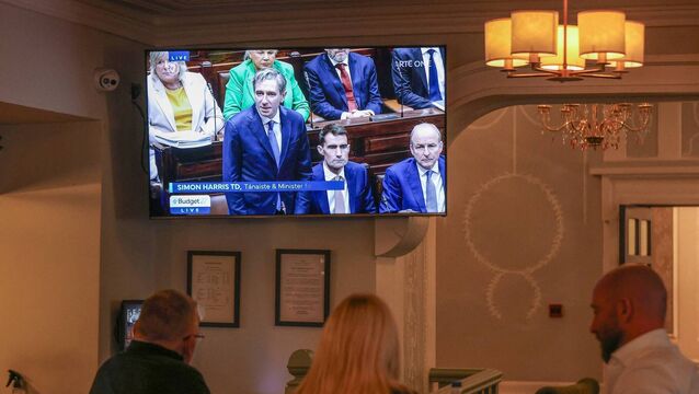 <p>People watch finance minister Simon Harris deliver the Budget live on TV in a bar near Goverment Buildings in Dublin on October 6, 2026. Picture: Paul Faith / AFP via Getty Images</p>
