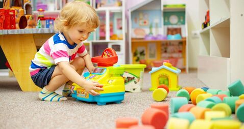 Child playing with colorful toys at the learning center or in kindergarten
