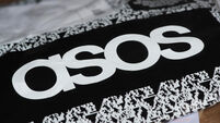 An ASOS delivery package resting on the floor along with letters received in the mail.