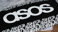 An ASOS delivery package resting on the floor along with letters received in the mail.
