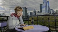 Mature Woman looks at the computer from La Defense, Seine River, Paris, France