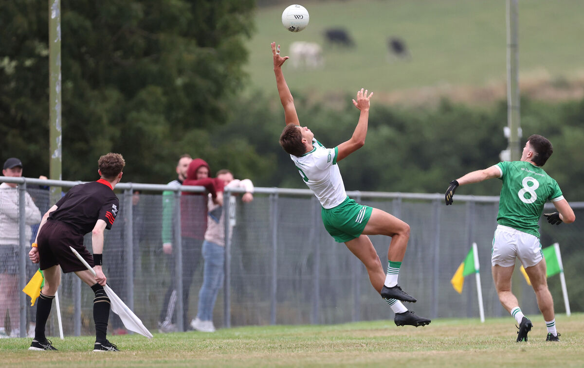 Alan Walsh, Kanturk, reaches for the ball to stop it going over the side line under pressure from Adam O'Donovan, Dohenys. Picture: Jim Coughlan. Alan Walsh, Kanturk, reaches for the ball to stop it going over the side line under pressure from Adam O'Donovan, Dohenys. Picture: Jim Coughlan.