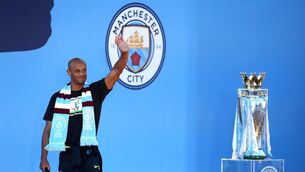 <p>Manchester City’s Vincent Kompany waves to fans during the trophy parade in Manchester.</p>