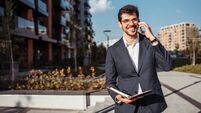 Handsome real estate agent on a street