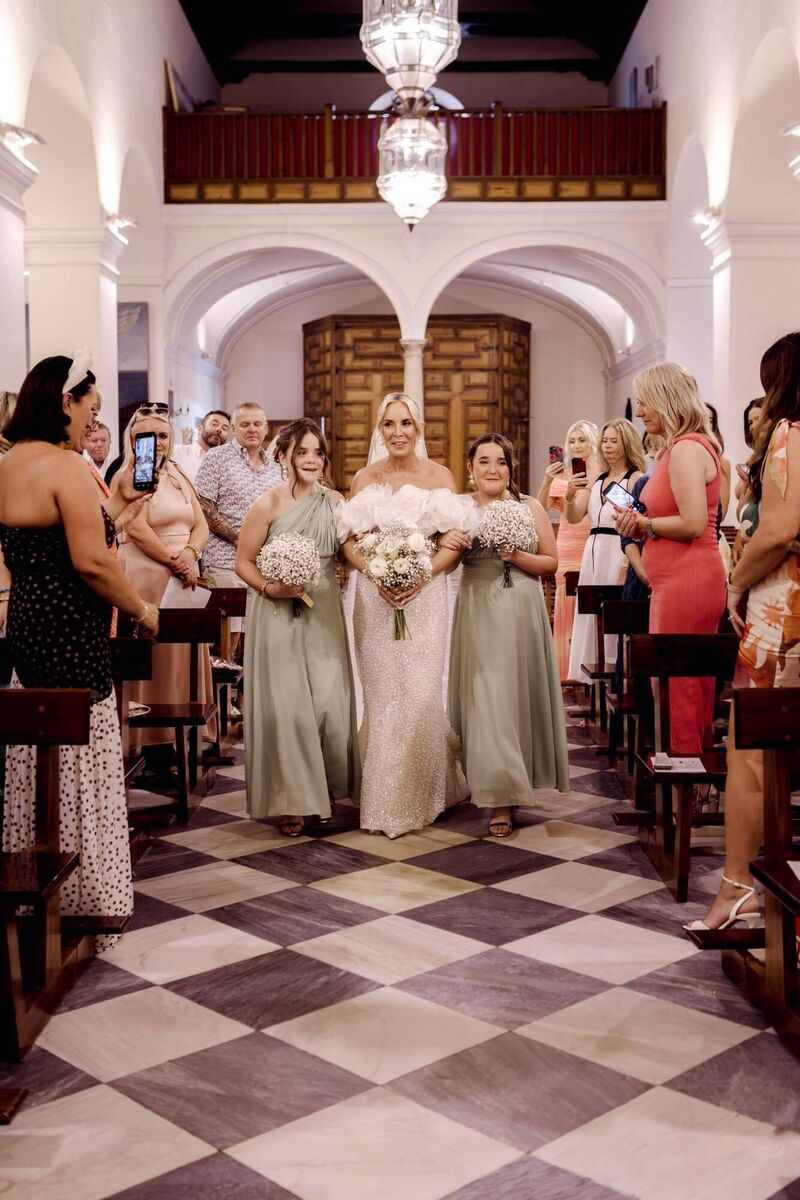 Orla Rall was accompanied up the aisle by her twin daughters and bridesmaids Gracie and Alex.