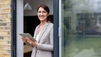 Conor_3_iStock-1643299991.jpg Happy real estate agent using a tablet while showing a property