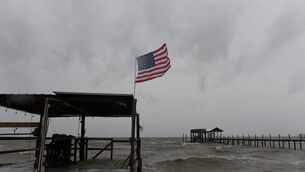 An American flag flaps in the wind generated by the effects of Isaias at Mon Louis Island, Alabama (Octavio Jones/AP) An American flag flaps in the wind generated by the effects of Isaias at Mon Louis Island, Alabama (Octavio Jones/AP)