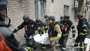 Rescue workers carry a body from the rubble of a residential building destroyed by a Russian airstrike in Zaporizhzhia, Ukraine, on Saturday (Kateryna Klochko/AP) Rescue workers carry a body from the rubble of a residential building destroyed by a Russian airstrike in Zaporizhzhia, Ukraine, on Saturday (Kateryna Klochko/AP)