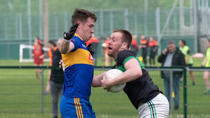 <p> Carrigaline's Eanna Desmond blocks Nemo Rangers Alan O'Donovan. Pic: Howard Crowdy</p>