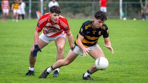 <p> BALL IN HAND: Buttevant’s Billy O’Riordan chased by Adrigole’s Tom O’Connor. Pic Chani Anderson</p>