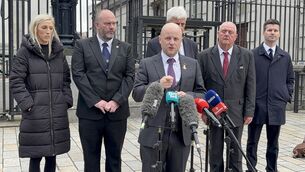 <p>Loyalist activist Jamie Bryson (centre), along with leading members of the Portadown District of the Orange Order, DUP MP Carla Lockhart and MLA Jonathan Buckley (far right) outside the High Court in Belfast. Picture: Rebecca Black/PA Wire</p>