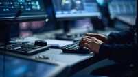 Close Up of a Professional Office Specialist Working on Desktop Computer in Modern Technological Monitoring Control Room with Di