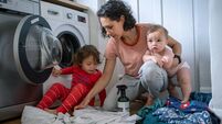 Mother and her son and daughter do laundry together