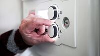 A pensioner adjusting the temperature control on his combi boiler. Redcar, UK. 26/5/2021. Photograph: Stuart Boulton.