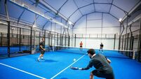 Padel_iStock-2218904611.jpg Group of skilled padel players playing padel match on new court indoors at night