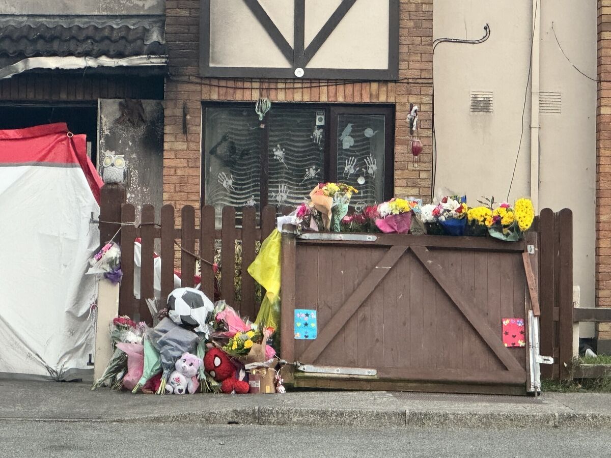 Floral tributes outside the scene of suspected arson attack at a house in Birchwood, Waterford, which claimed the lives of two adults and two children. Picture: Micheal O Scannail/the Press Association