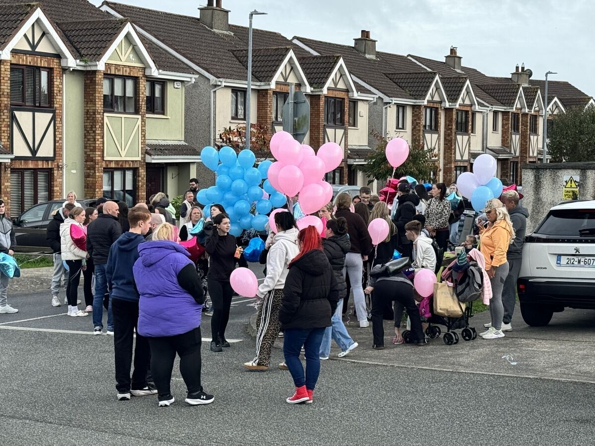 People gather ahead of a balloon release ceremony, to commemorate the lives lost in a house fire in Birchwood, Waterford. Picture: Micheal O Scannail/the Press Association