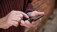 Hands of Senior Man Texting on Mobile Phone Outdoors in NYC USA