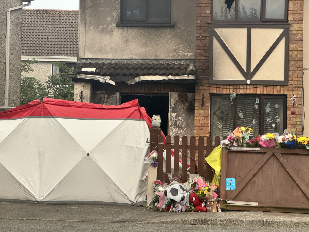 Floral tributes outside the scene of suspected arson attack at a house in Birchwood, Waterford, which claimed the lives of two adults and two children. Picture: PA Floral tributes outside the scene of suspected arson attack at a house in Birchwood, Waterford, which claimed the lives of two adults and two children. Picture: PA