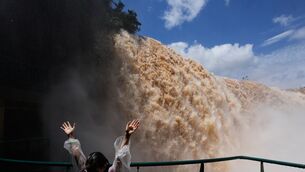 A tourist stands on a walkway overlooking Iguazu Falls (Jorge Saenz/AP) A tourist stands on a walkway overlooking Iguazu Falls (Jorge Saenz/AP)