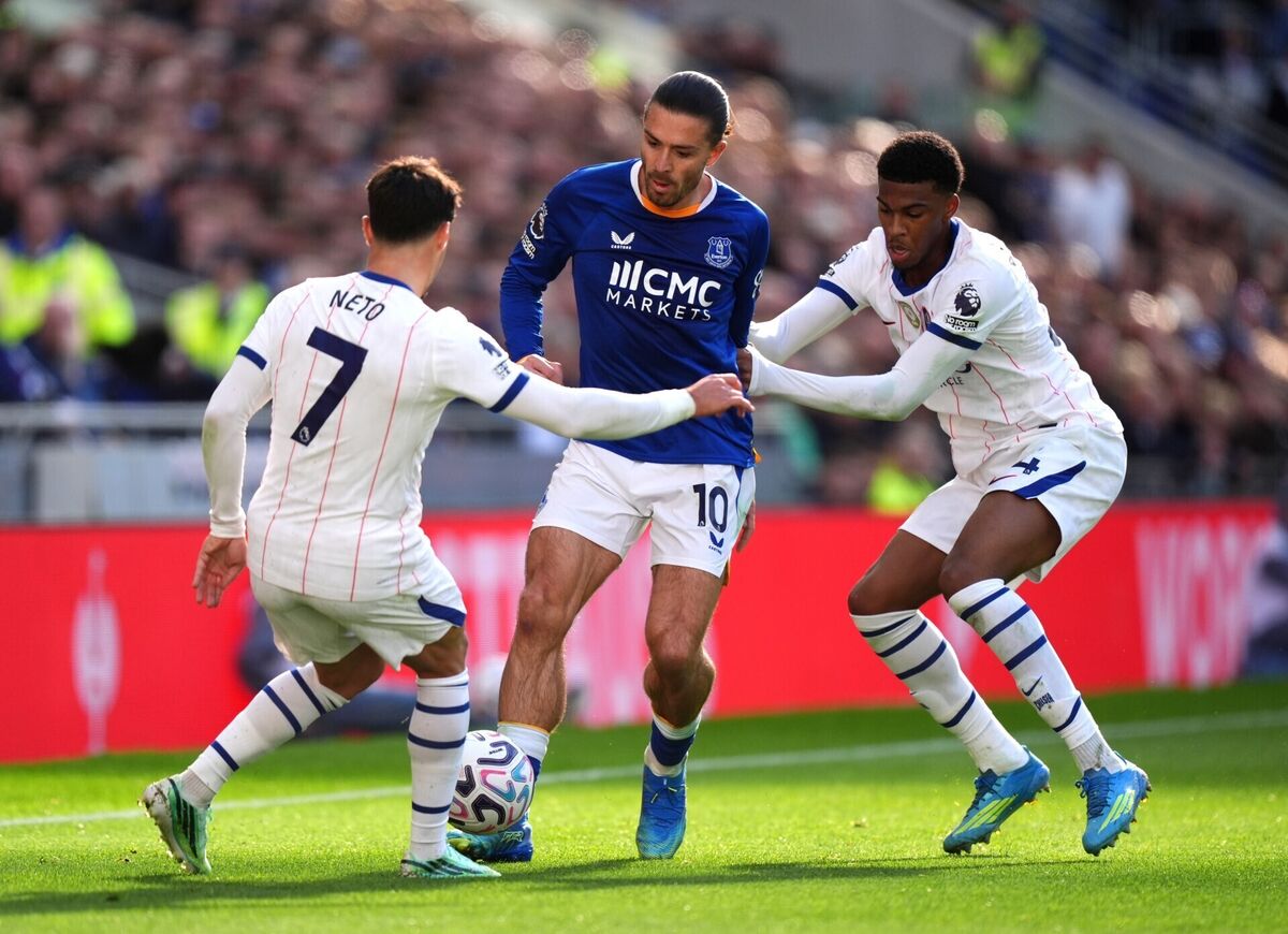 Chelsea's Pedro Neto, Everton's Jack Grealish, and Chelsea's Josh Acheampong battle for the ball Chelsea's Pedro Neto, Everton's Jack Grealish, and Chelsea's Josh Acheampong battle for the ball