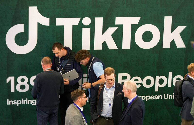 Delegates stand in front of a TikTok poster during the file picture: International AI Summit in Dublin, on October 14. Paul Faith/AFP/Getty Delegates stand in front of a TikTok poster during the file picture: International AI Summit in Dublin, on October 14. Paul Faith/AFP/Getty