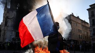 <p>A protester waving a French national flag in Marseille, southern France, on October 17. Photo: Thibaud Moritz / AFP via Getty Images</p> <p>A protester waving a French national flag in Marseille, southern France, on October 17. Photo: Thibaud Moritz / AFP via Getty Images</p>