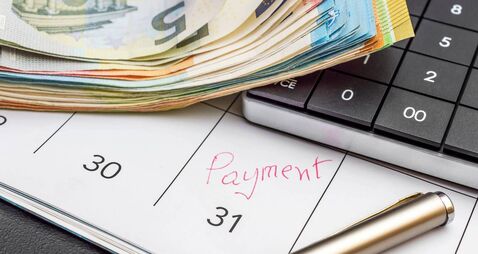 Last day of month - payment deadline. Calculator with money  on the calendar with last day of month.