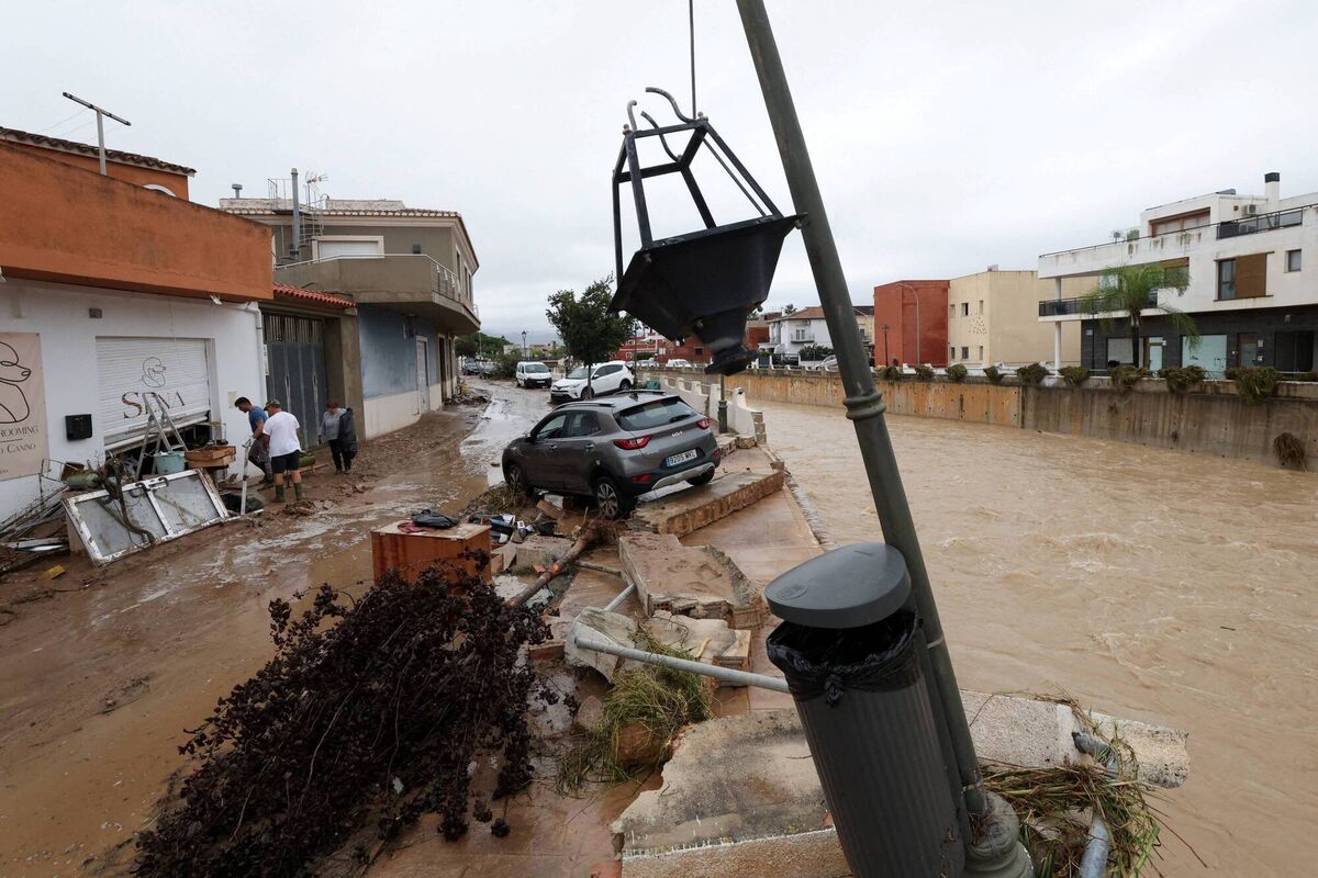 A car on the damaged bank of a waterway in Els Poblets, Spain. (REUTERS/Eva Manez). A car on the damaged bank of a waterway in Els Poblets, Spain. (REUTERS/Eva Manez).
