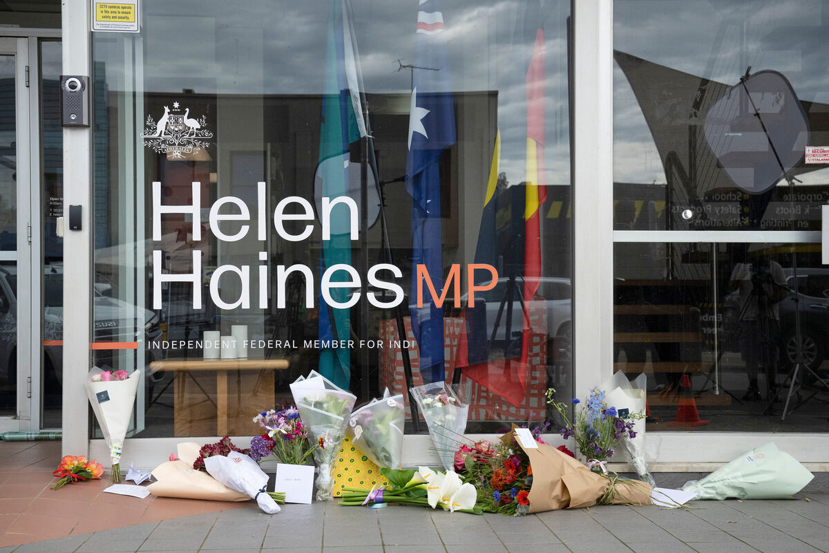 Tributes and flowers are placed outside the electoral office for independent member of parliament Helen Haines in Wangaratta, Australia. Picture: James Ross/AAP image via AP Tributes and flowers are placed outside the electoral office for independent member of parliament Helen Haines in Wangaratta, Australia. Picture: James Ross/AAP image via AP