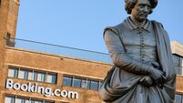 Booking.com HQ headquarters head office building on the Rembrandtplein Rembrandt Square with the statue of Rembrandt. Amsterdam.