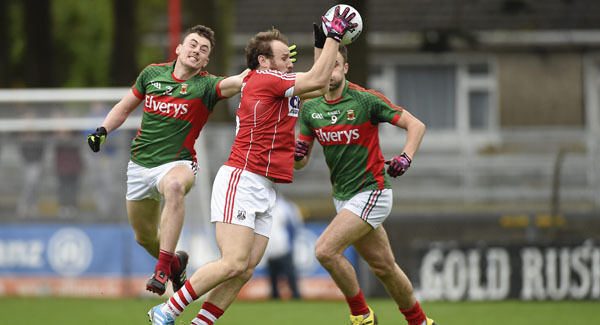 Brian O'Driscoll, Cork, in action against Diarmuid O'Connor, left, and Jason Gibbons, Mayo.