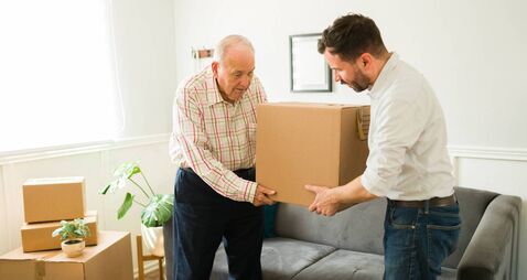 Moving home iStock-1428205127.jpg Elderly man moving into a new apartment with the help of his son
