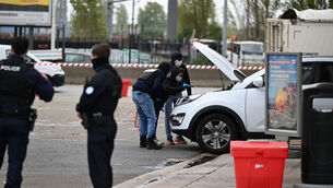 Police search a car at a petrol station after a shooting in Trappes, outside Paris (Emma Da Silva/AP) Police search a car at a petrol station after a shooting in Trappes, outside Paris (Emma Da Silva/AP)