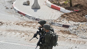 Israeli soldiers take up positions during an army operation in the West Bank city of Hebron (Mahmoud Illean/AP) Israeli soldiers take up positions during an army operation in the West Bank city of Hebron (Mahmoud Illean/AP)