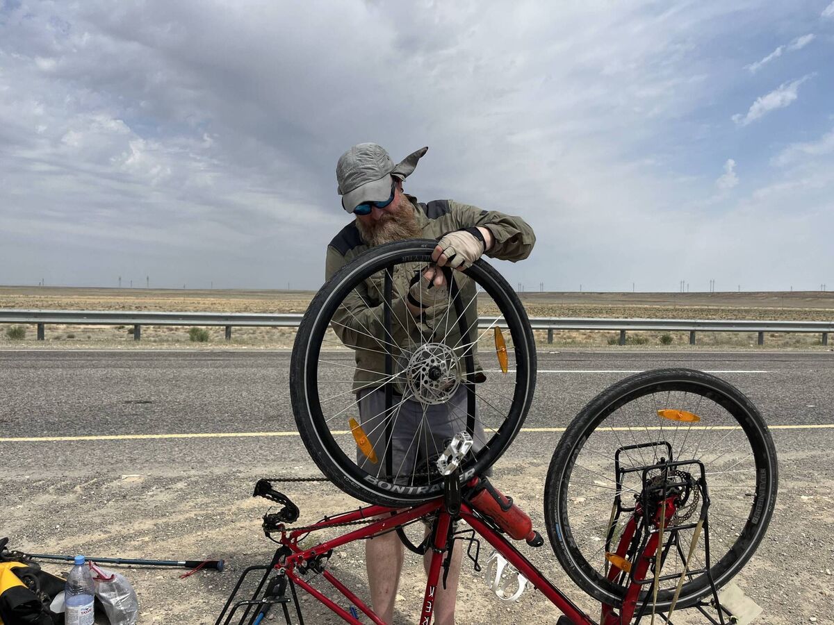 Mark fixing a puncture in Kazakhstan Desert. Mark fixing a puncture in Kazakhstan Desert.