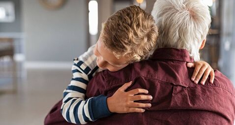Attached child hugging his grandfather