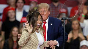 Nicki Minaj waves alongside US President Donald Trump (AP Photo/Duane Burleson)