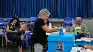 A woman casts her ballot at a polling station during Israel’s general election (Ohad Zwigenberg/AP)