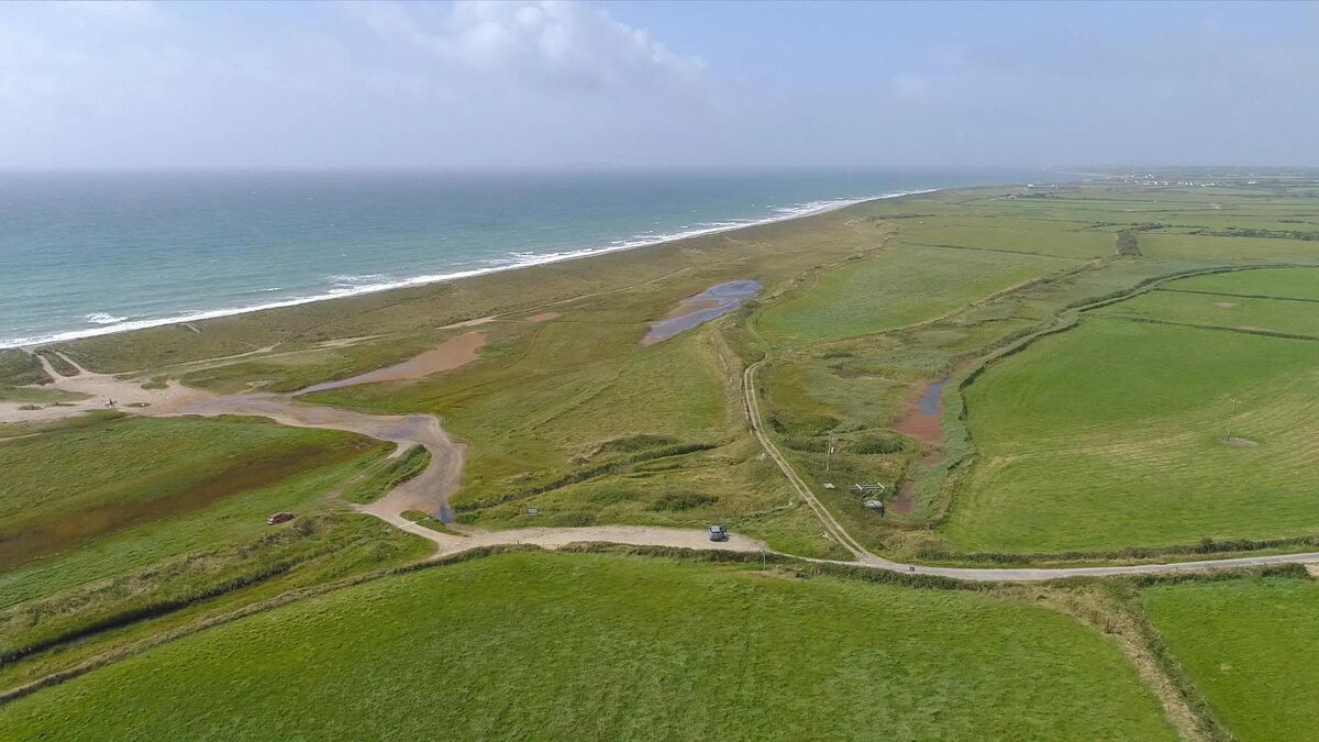 View towards the sea with access road to the farm.