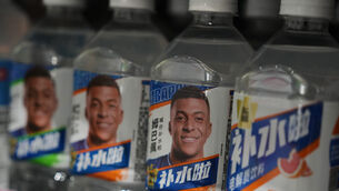 Bottles of an electrolyte drink featuring images of French football star Kylian Mbappe on sale at a supermarket in Beijing (Andy Wong/AP) Bottles of an electrolyte drink featuring images of French football star Kylian Mbappe on sale at a supermarket in Beijing (Andy Wong/AP)