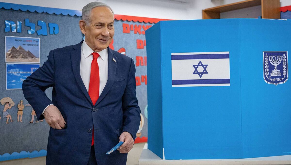 Israel's prime minister Benjamin Netanyahu reacts after filling out his ballot before voting at a polling station in Jerusalem on the day of Israel's legislative election. Picture: Yonatan Sindel / POOL / AFP via Getty Images