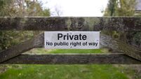 Private sign on a wooden gate to a field